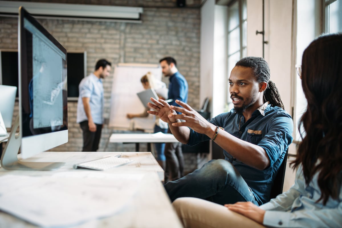 Co-workers discuss lean product development